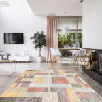 Rug on hardwood floor in a stylish, open space living room inter